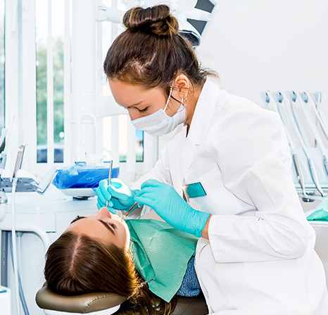 A dentist working with a child patient.